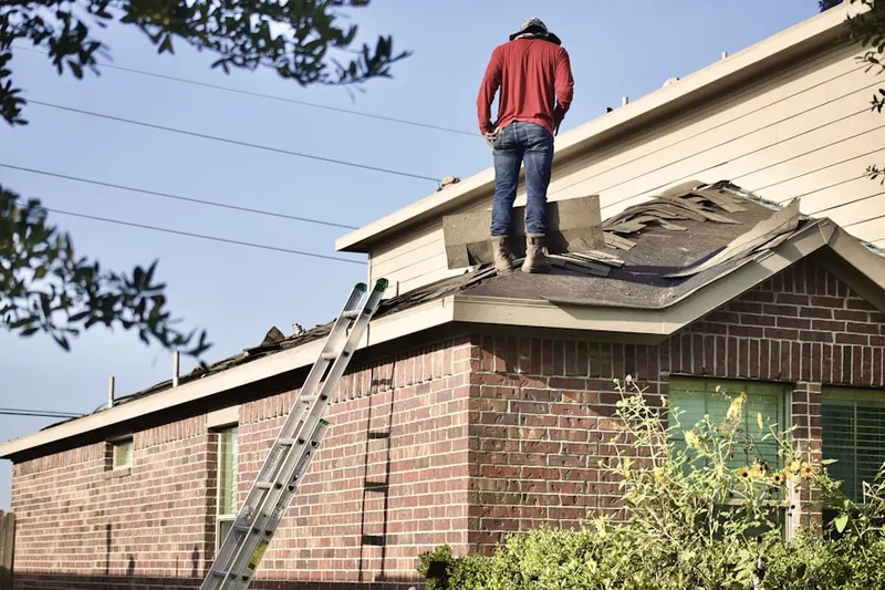 Professional roofer working on a residential roof in West Falls Church